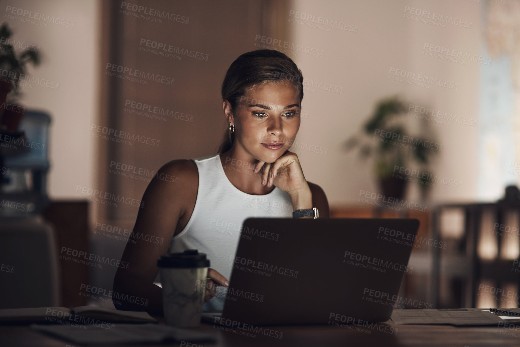 Buy stock photo Shot of a young businesswoman using a laptop during a late night at work