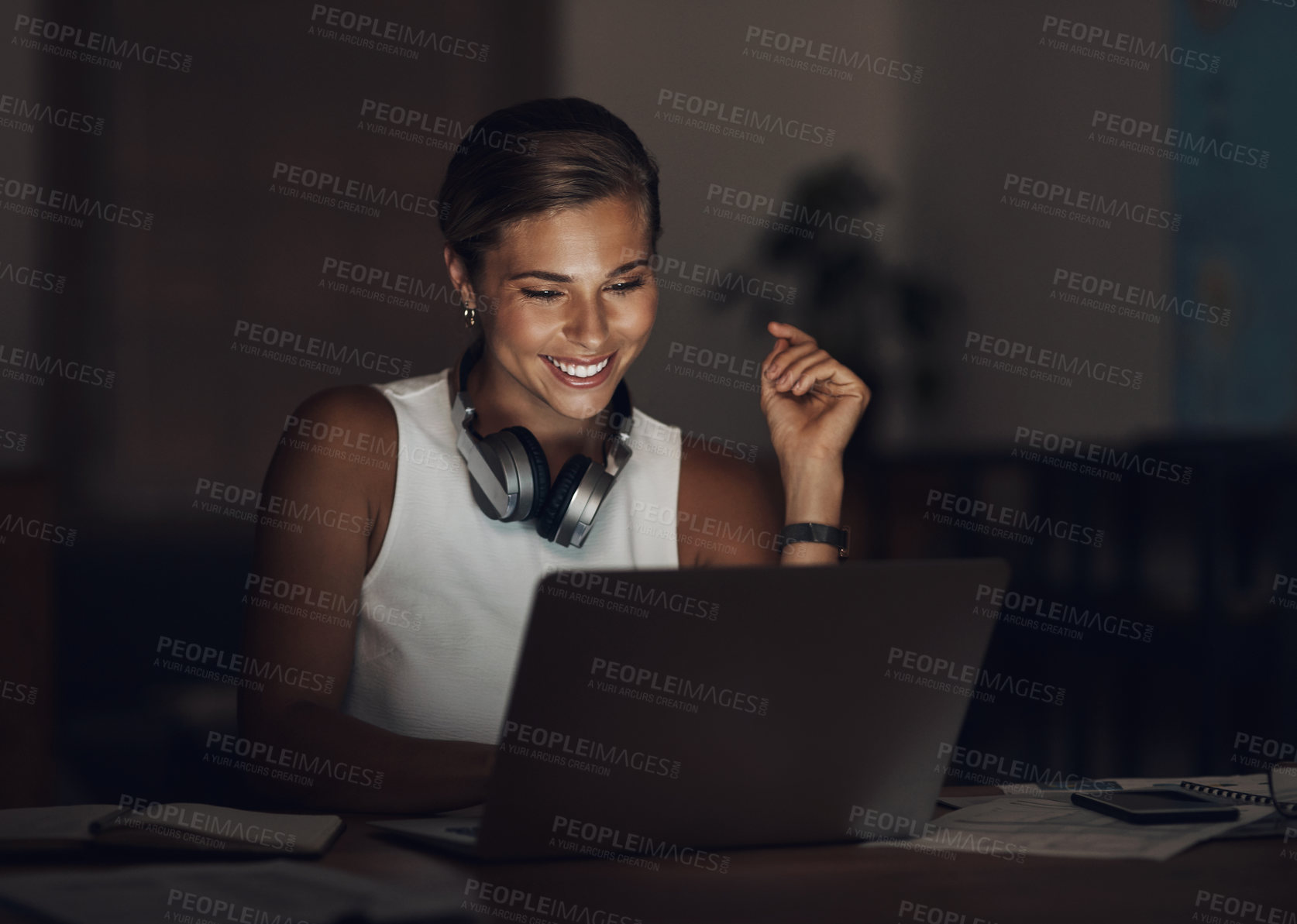 Buy stock photo Shot of a young businesswoman using a laptop during a late night at work