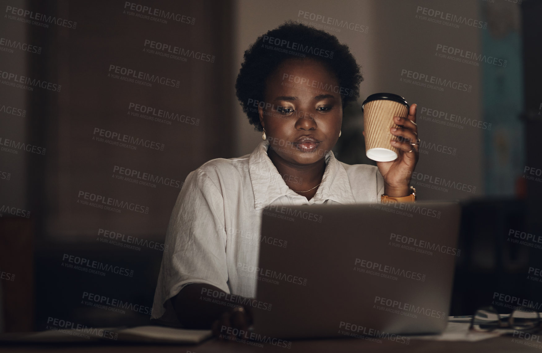 Buy stock photo Shot of a young businesswoman having coffee and using a laptop during a late night at work