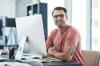 Buy stock photo Portrait of a young businessman using a computer in a modern office