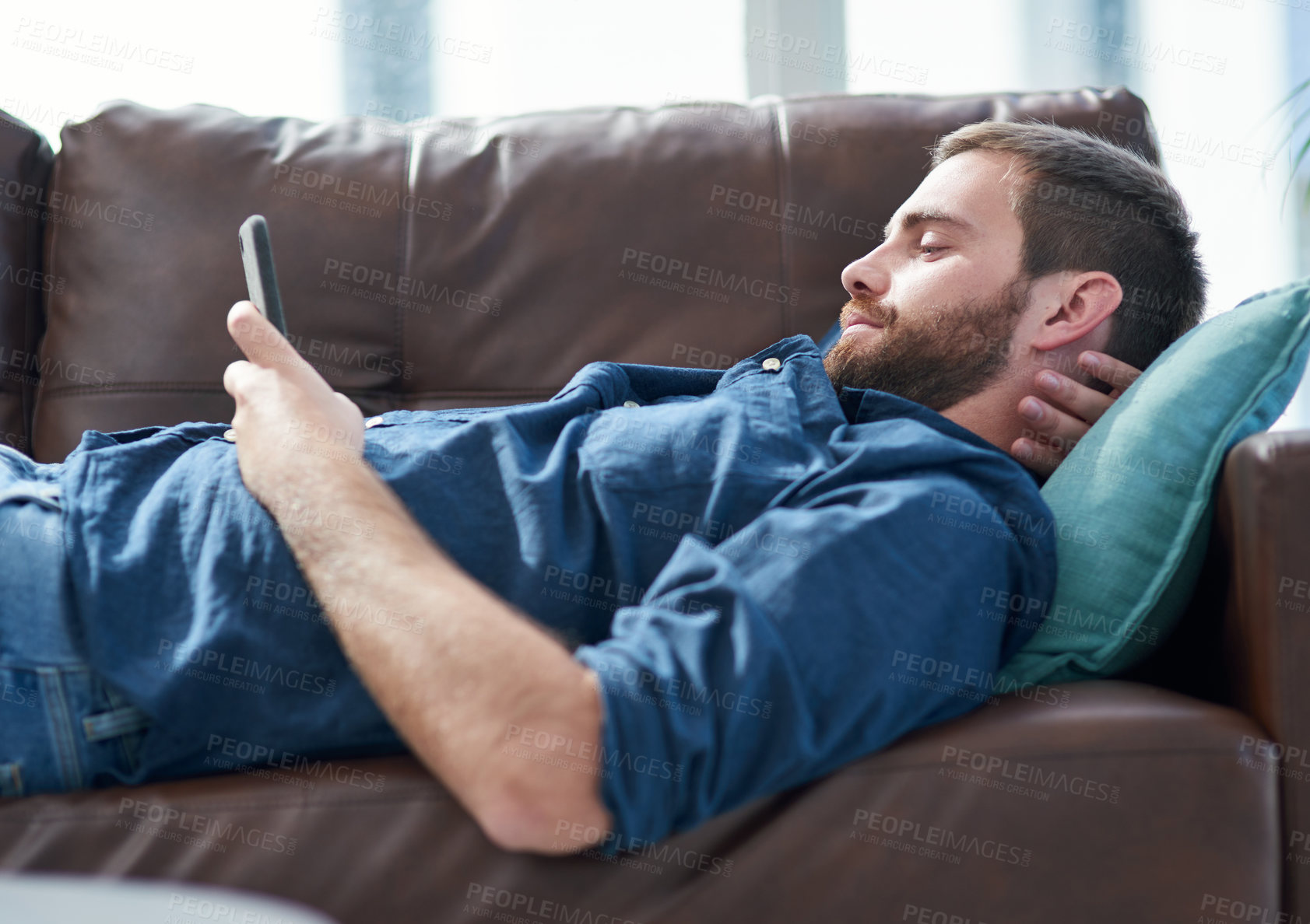 Buy stock photo Phone, relax and man on sofa in home reading online blog with social media, website or internet. Communication, cellphone and male person resting in living room for networking on mobile app at house.