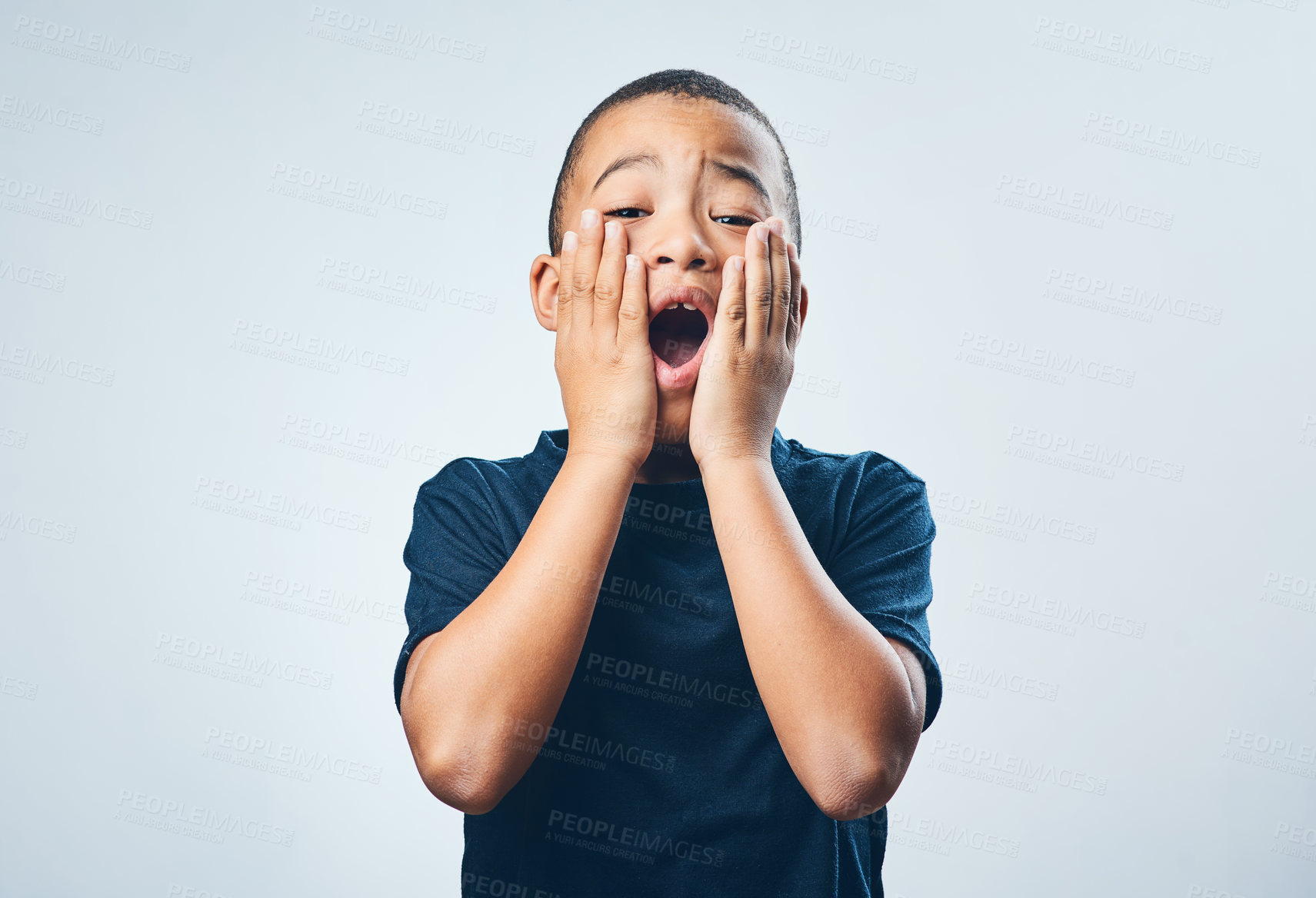 Buy stock photo Studio shot of a cute little boy looking amazed against a grey background