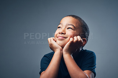 Buy stock photo Studio shot of a cute little boy looking thoughtful against a grey background