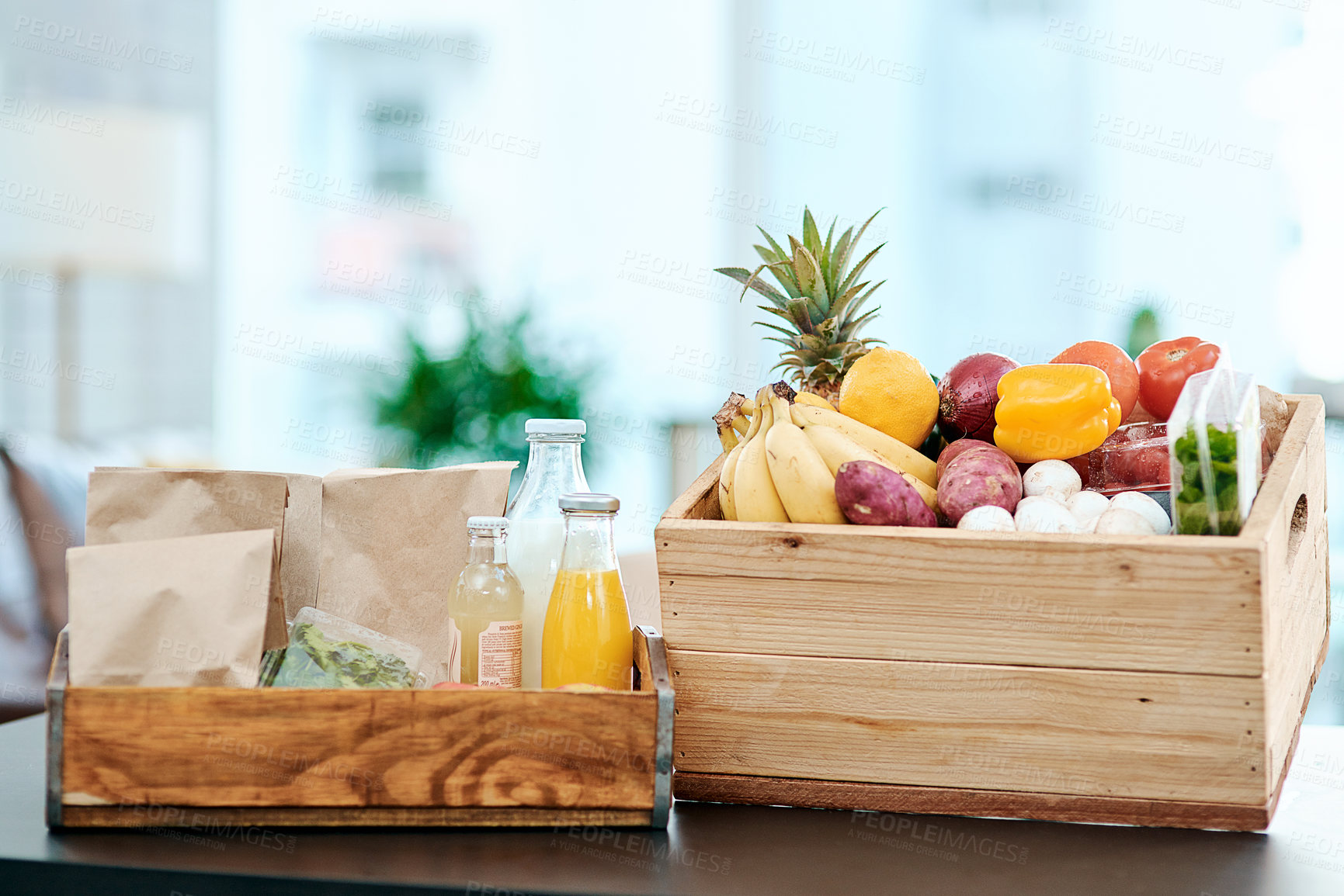 Buy stock photo Shot of a box full of fresh produce on a kitchen counter at home
