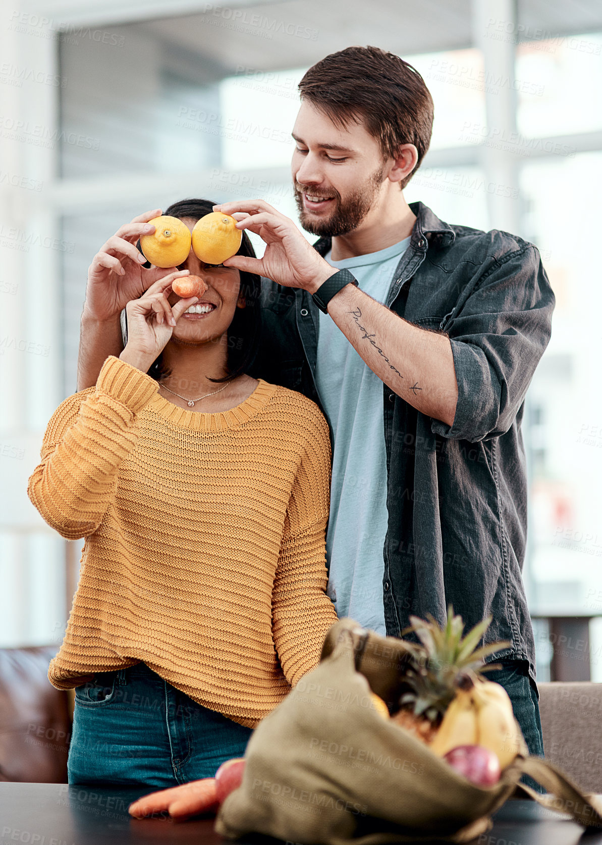 Buy stock photo Grocery, vegetables and funny with couple in house for goofy, shopping list and supermarket. Nutrition, food and wellness with man and woman playful at home for consumer, comedy and fruit together