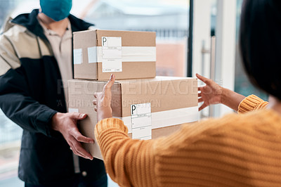 Buy stock photo Shot of a masked young man delivery a package to a woman at home
