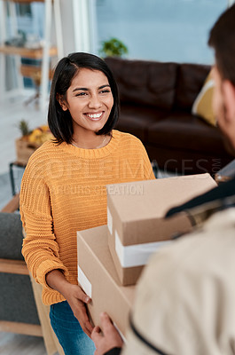 Buy stock photo Shot of a young woman receiving a package from a delivery man at home