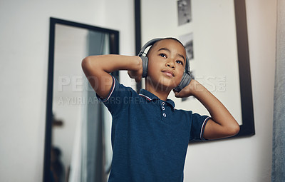 Buy stock photo Dance, music and thinking with black child in bedroom of home for morning or weekend fun and games. Development, headphones and listening to radio with serious African boy in apartment for growth