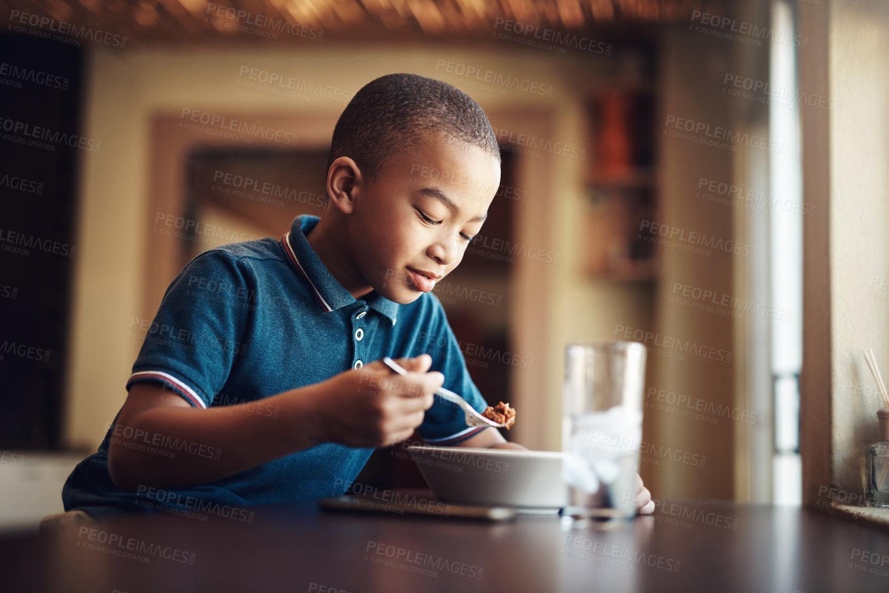 Buy stock photo African kid, boy or eating food in home for nutrition, hungry or healthy development at table. Happy child, pasta or spaghetti meal in house for lunch, dinner or cuisine with water at kitchen counter