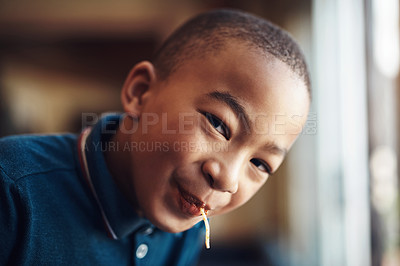 Buy stock photo Cropped shot of a young boy eating spaghetti at home