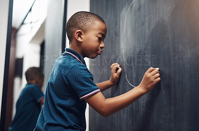 Buy stock photo Blackboard, drawing and education with boy student in classroom of school for growth or learning. Chalkboard, development and picture with child in lesson for academic knowledge, scholarship or study