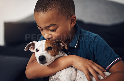 Buy stock photo Shot of an adorable little boy playing with his pet dog on the bed at home