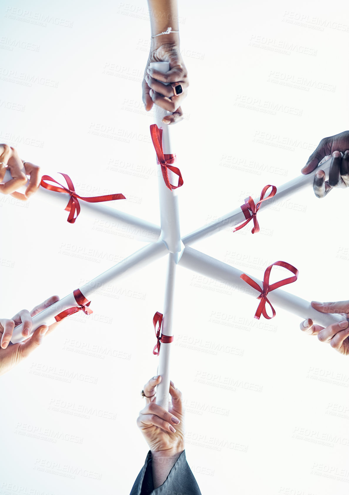 Buy stock photo Low angle shot of a group of students holding their diplomas together on graduation day