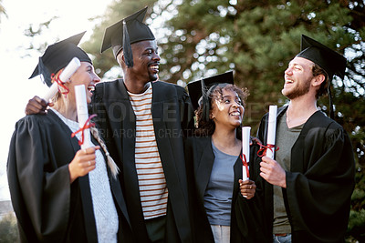 Buy stock photo Shot of a group of students standing together on graduation day