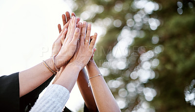 Buy stock photo Closeup shot of a group of students giving each other a high five on graduation day