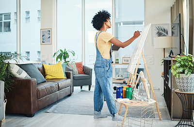 Buy stock photo Shot of a young artist painting on a canvas at home