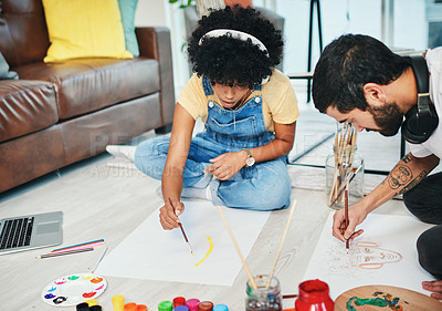 Buy stock photo Shot of a young couple painting together at home