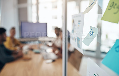Buy stock photo Closeup shot of notes on a glass wall in an office with businesspeople in the background