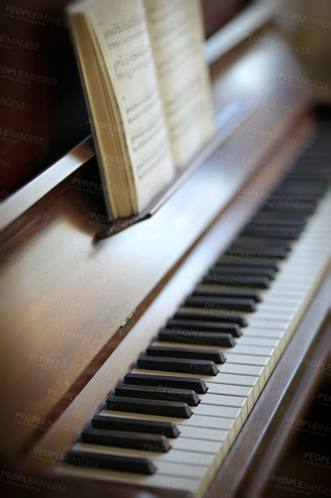 Buy stock photo Closeup of a vintage piano and keyboard with a sheet music book. An empty antique or wooden musical instrument for playing classical jazz or used for old traditional songwriting and rehearsals