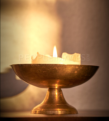 Buy stock photo Lit candle on a table at home for warmth and brightness. Beautiful house decoration used for aroma, good scent and to bring light to a room. Candles represent light, illumination, and purification