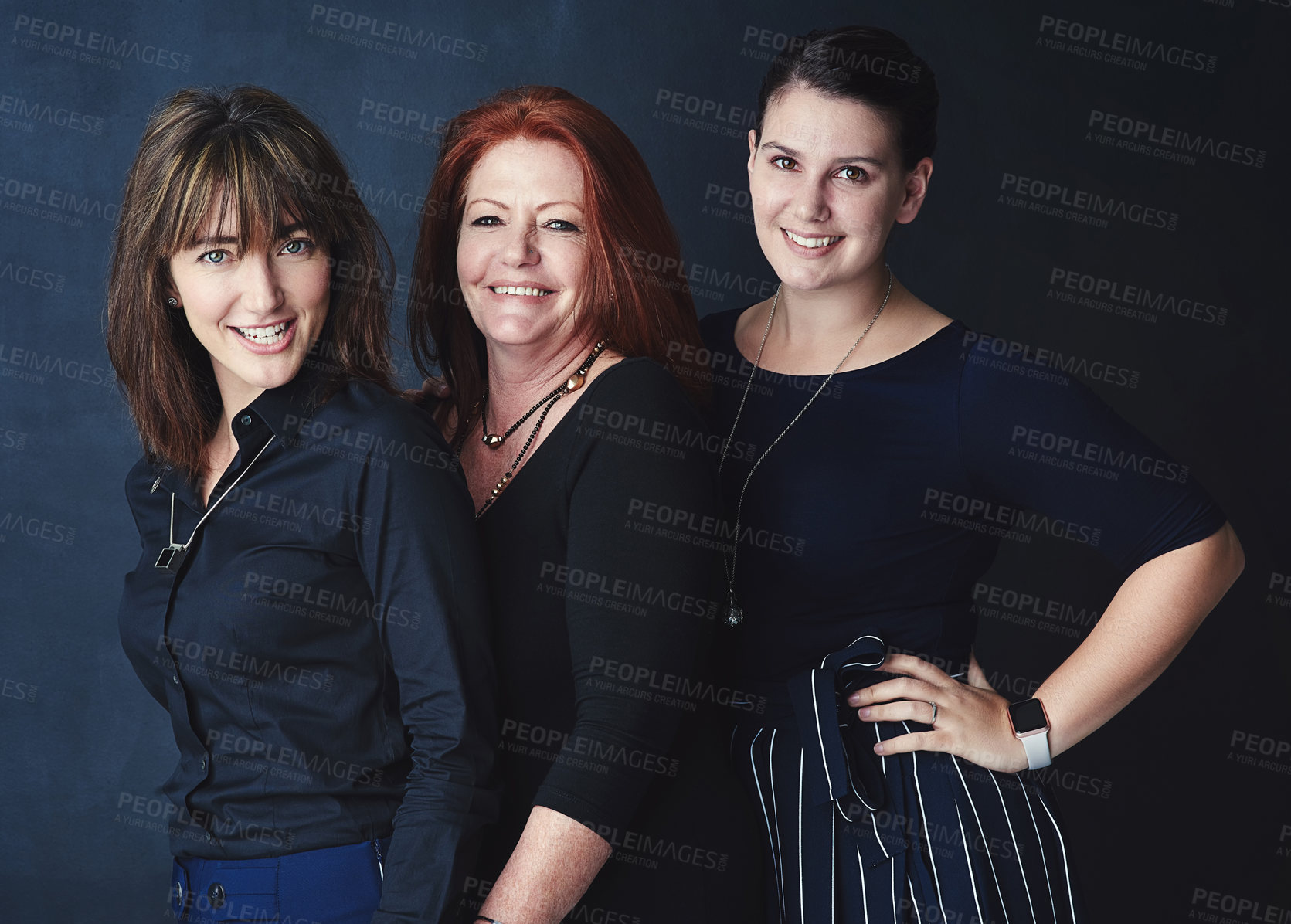 Buy stock photo Shot portrait of three businesswomen standing together against a dark background