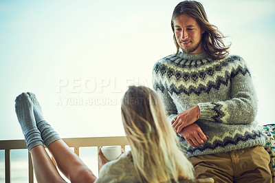 Buy stock photo Shot of a young couple relaxing on their balcony