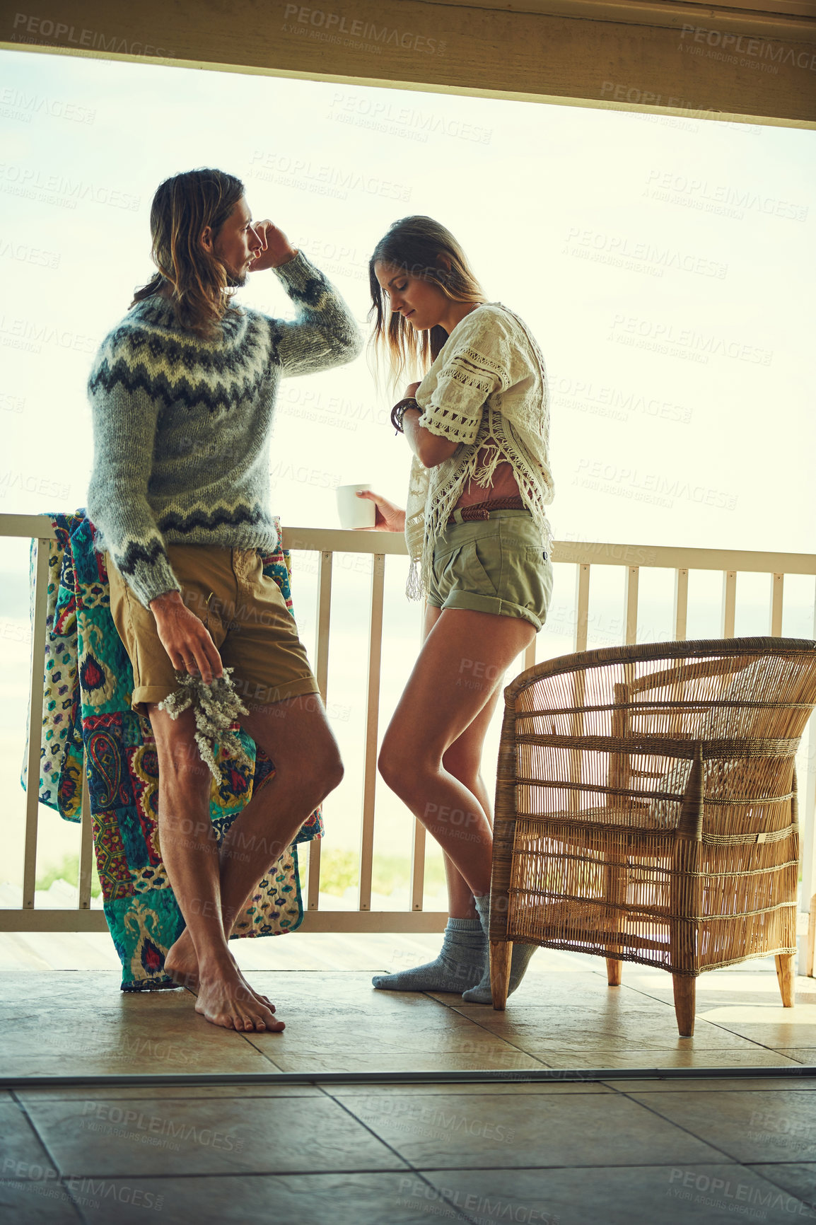 Buy stock photo Shot of a young couple relaxing on their balcony