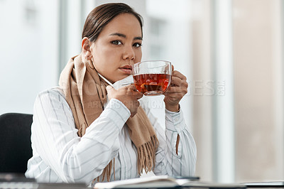 Buy stock photo Shot of a young businesswoman having a glass of herbal tea at her desk in a modern office