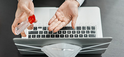 Buy stock photo Cropped shot of a businesswoman using hand sanitiser while using a laptop in a modern office