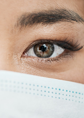 Buy stock photo Closeup shot of a woman's eye while wearing a mask on her face