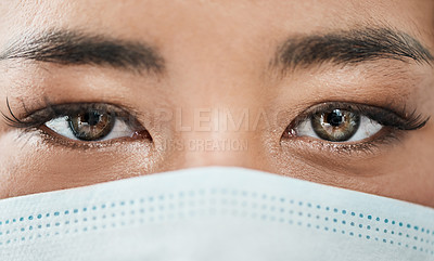 Buy stock photo Closeup shot of a woman's eyes while wearing a mask on her face
