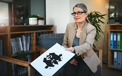 Buy stock photo Shot of a mature psychologist conducting an inkblot test during a therapeutic session