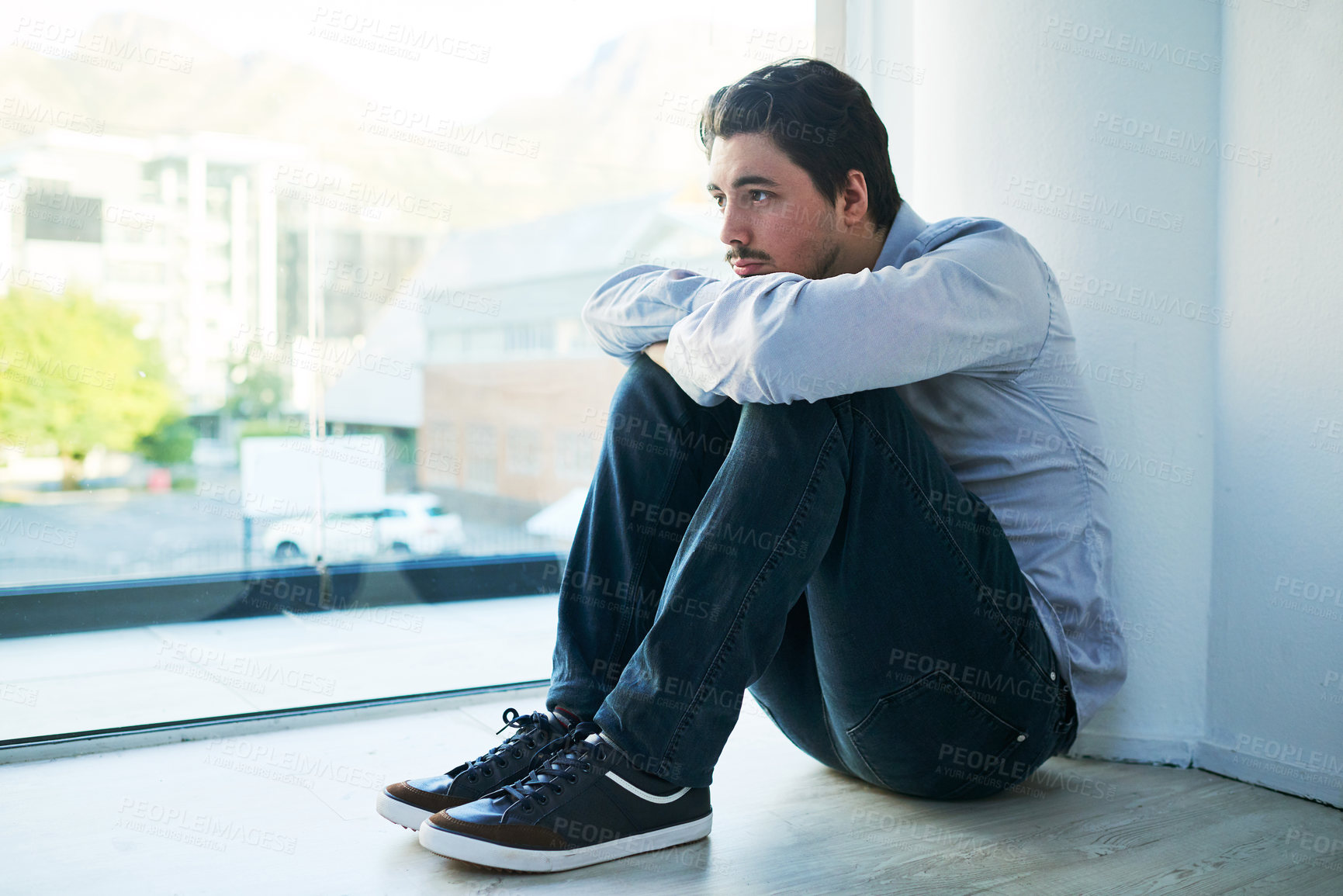 Buy stock photo Shot of a young man suffering from a mental breakdown