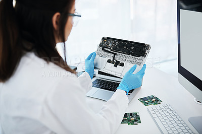 Buy stock photo Shot of a young woman repairing computer hardware in a laboratory