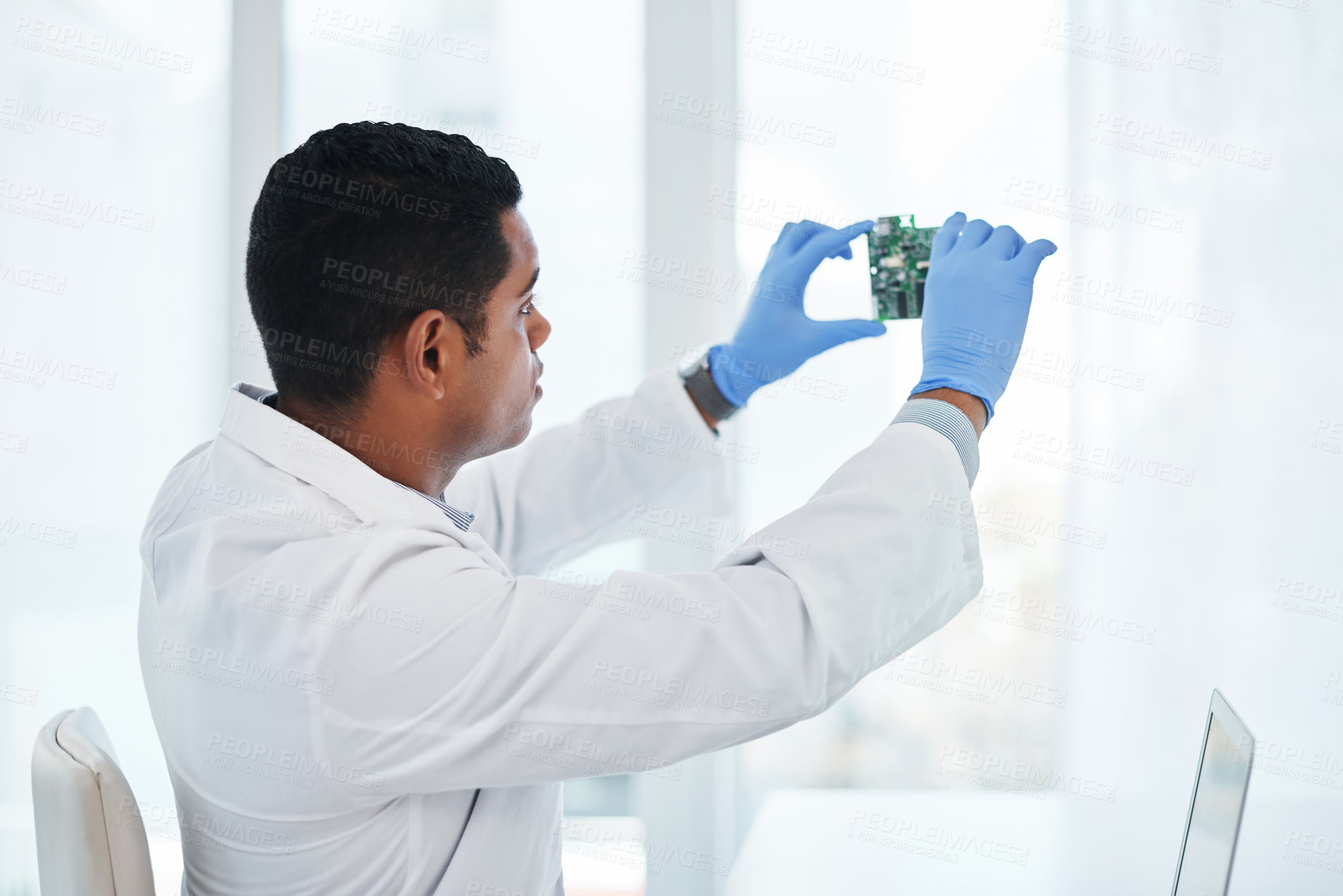 Buy stock photo Shot of a young man repairing computer hardware in a laboratory