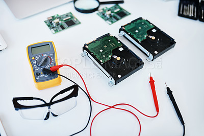 Buy stock photo Shot of a multimeter testing the voltage of computer hardware
