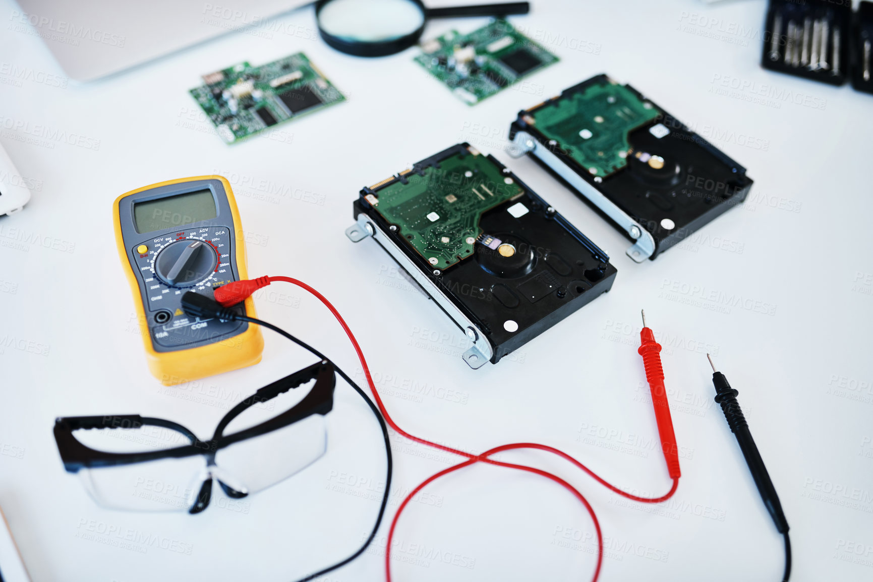 Buy stock photo Shot of a multimeter testing the voltage of computer hardware