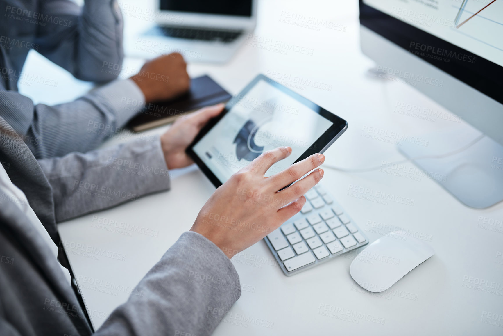 Buy stock photo Shot of a businessman using a digital tablet to analyse financial data in a modern office