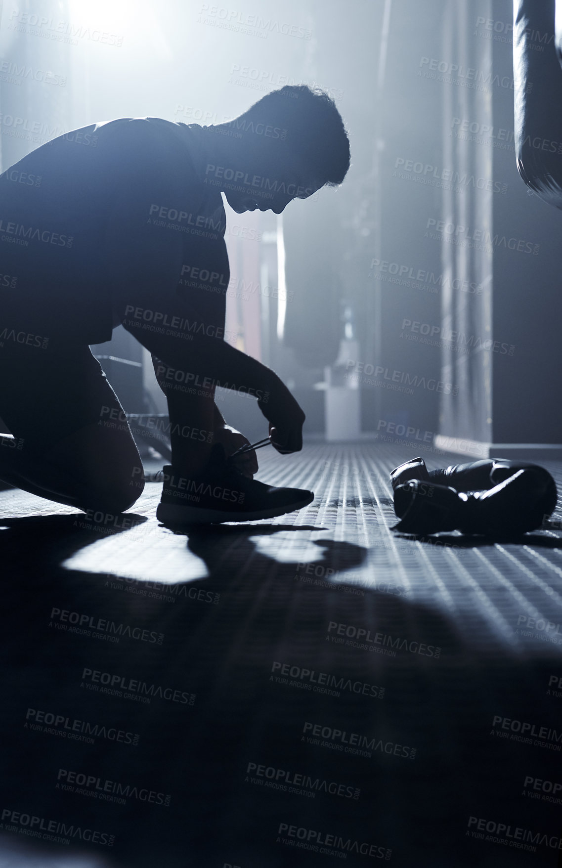 Buy stock photo Man, boxer and tying laces at gym, fitness athlete and getting ready for exercise or workout. Male person, fight preparation and fixing shoes at health centre, footwear and start of boxing sports