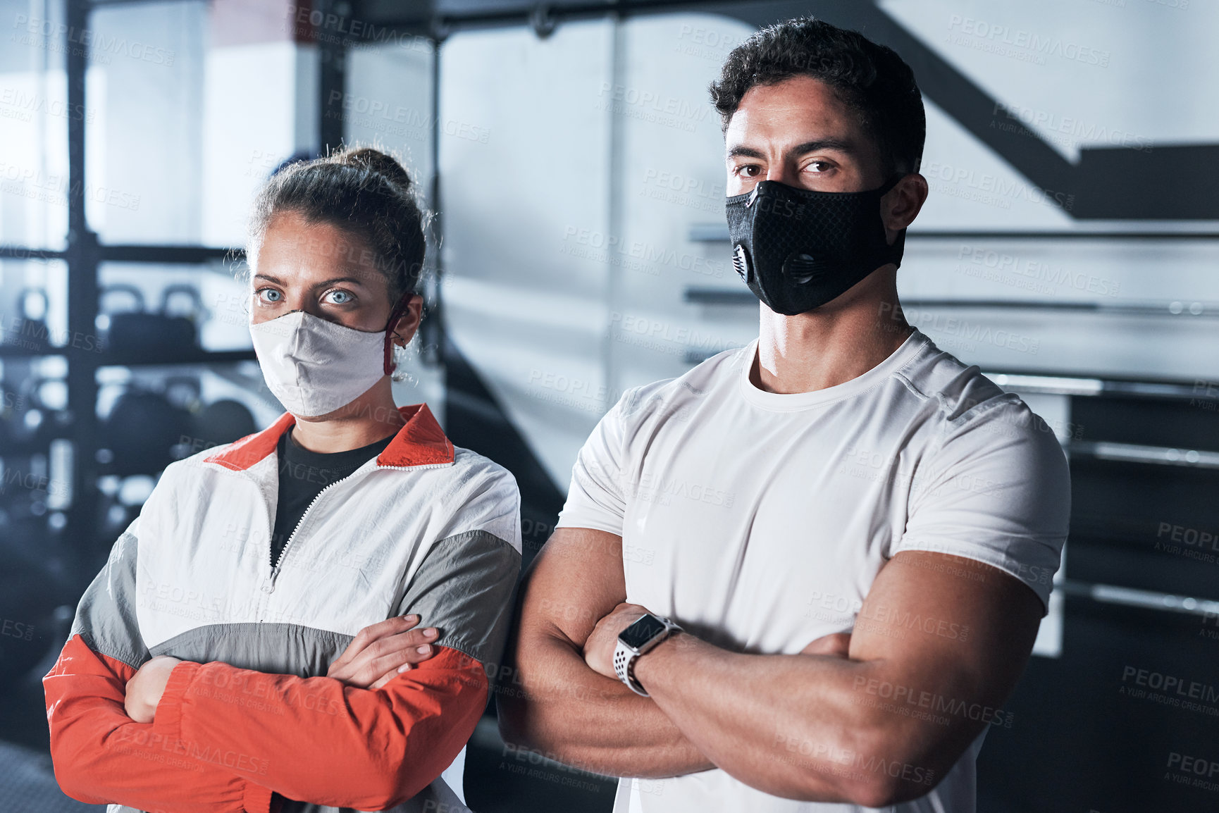Buy stock photo Portrait of two sporty young people wearing face masks in a gym