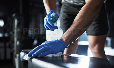 Buy stock photo Gym, person and hands with equipment for cleaning, hygiene or health to reduce bacteria for workout. Fitness club, spray and janitor with gloves for virus safety, wipes dust or liquid soap with cloth