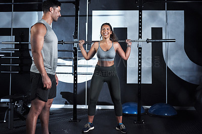 Buy stock photo Shot of a young woman lifting a steel pole during her workout at a gym