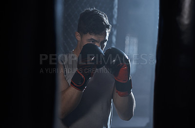 Buy stock photo Man, boxing bag and gloves with punch at gym of mma workout, sports training and fight performance. Strong, male boxer and fitness with power challenge, self defence and resilience of combat practice