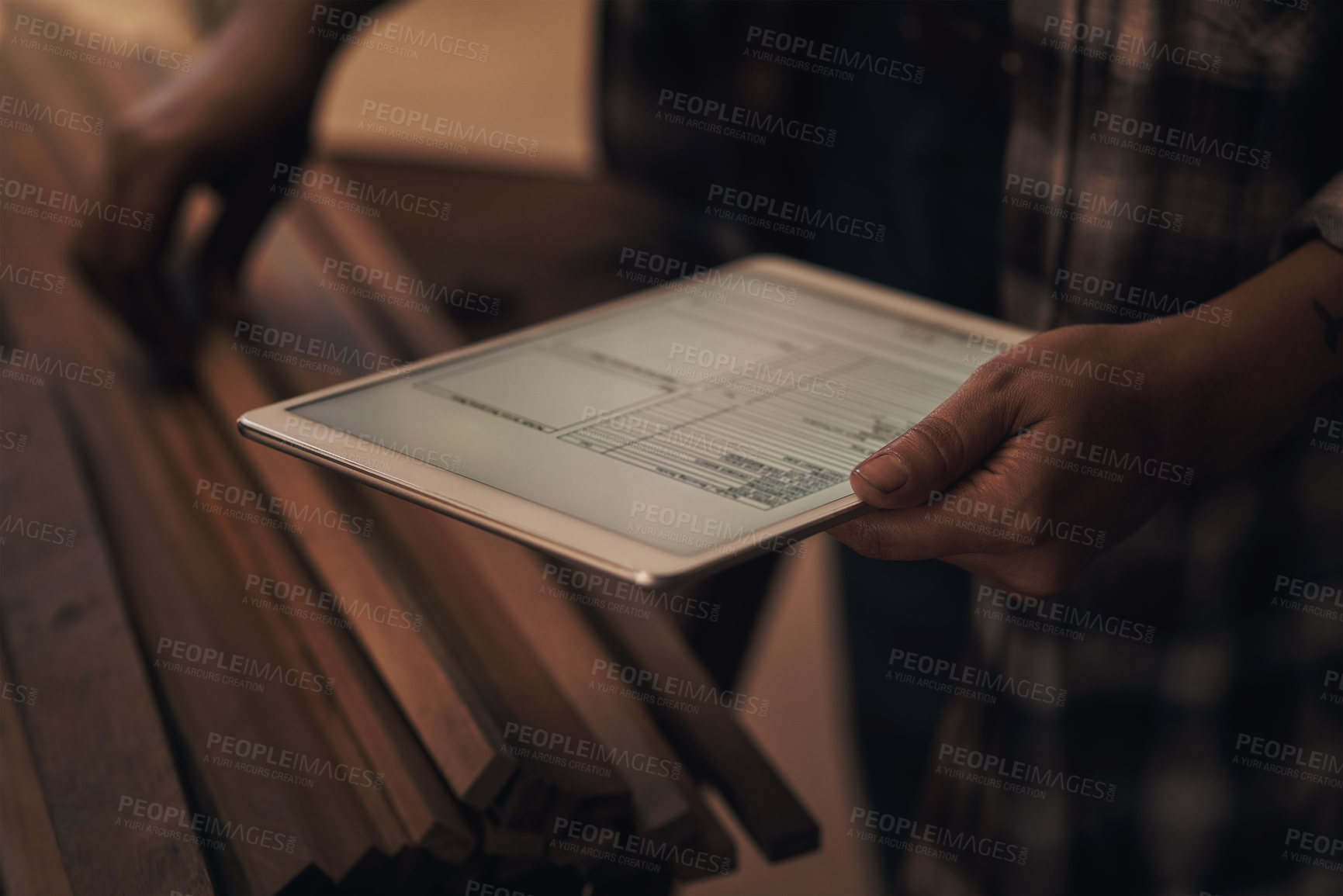 Buy stock photo Cropped shot of a woman using a digital tablet while working at a foundry