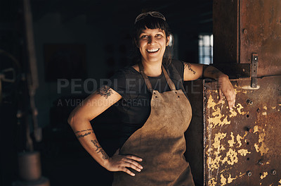 Buy stock photo Woman blacksmith, portrait and happy in workshop for industry, trade or entrepreneurship in foundry. Small business owner, female entrepreneur or labor in factory, industrial warehouse or metalwork