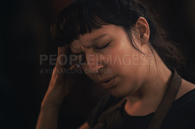 Buy stock photo Shot of a young woman experiencing stress while working at a foundry
