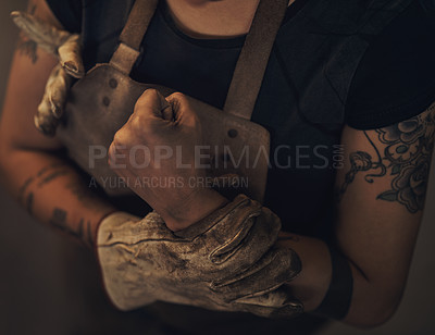 Buy stock photo Shot of a woman experiencing wrist pain while working at a foundry