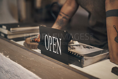 Buy stock photo Shot of a woman standing at the front desk with an open sign of a foundry