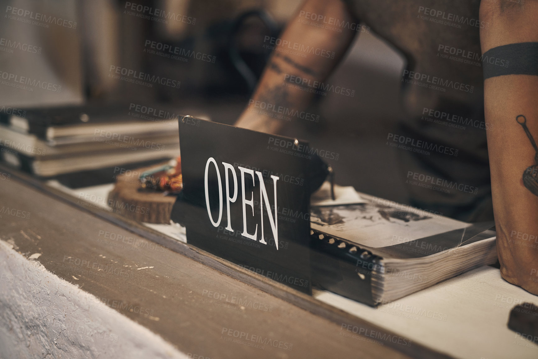 Buy stock photo Shot of a woman standing at the front desk with an open sign of a foundry