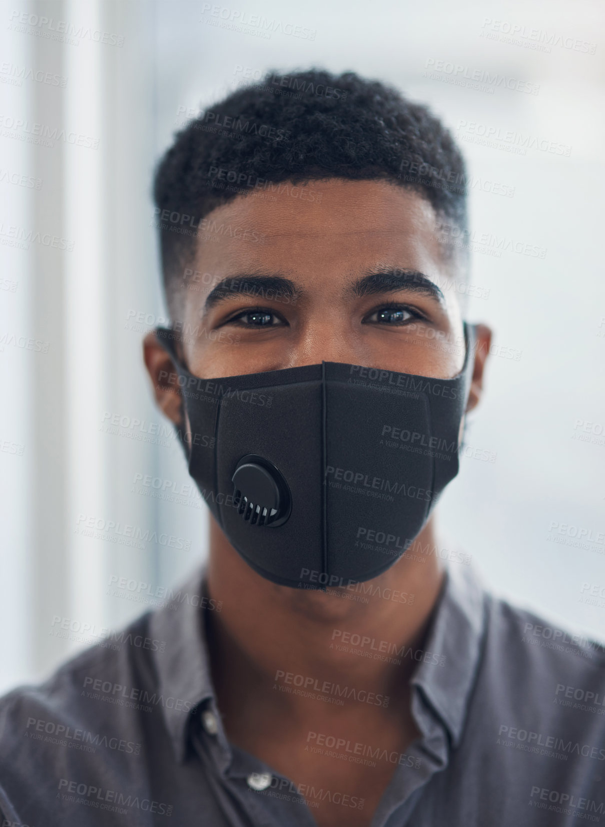 Buy stock photo Portrait of a young businessman wearing a face mask in an office